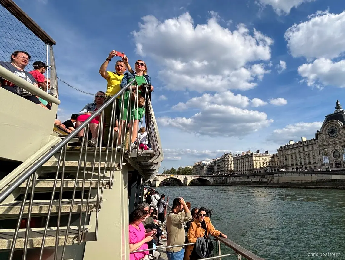 Üst güvertedeki yolcular ve Seine kıyısındaki Musée d'Orsay, Paris tekne turları