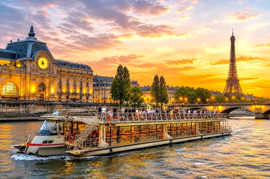 Illuminated Seine River night cruise boat lit up near the Eiffel Tower